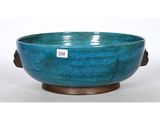 an image of a blue bowl sitting on top of a wooden stand