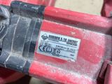 a close up of a red and black machine with a label on it