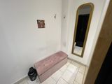 a bench in the corner of a room with a mirror on the wall