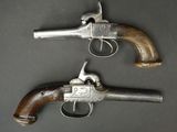a pair of colt colt colt pistols with wooden grips and wooden grips
