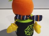 an orange that is wearing a hat and scarf