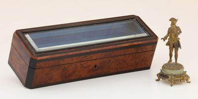 a small wooden box with a figurine next to it