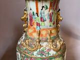 a vase that has a picture of people on it