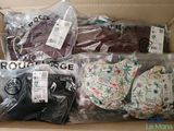 a cardboard box filled with assorted men ' s clothing