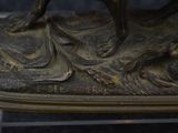 a bronze statue of a man riding a horse