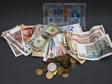 un portefeuille rempli de billets et de pièces posé sur une table