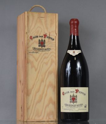 a bottle of wine sitting next to a wooden box