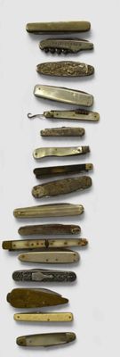several different types of knives are lined up on a white surface