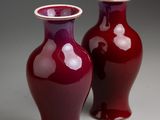 two vases sitting side by side on a table