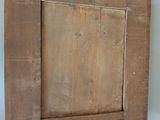 a picture of a wooden picture frame hanging on the wall