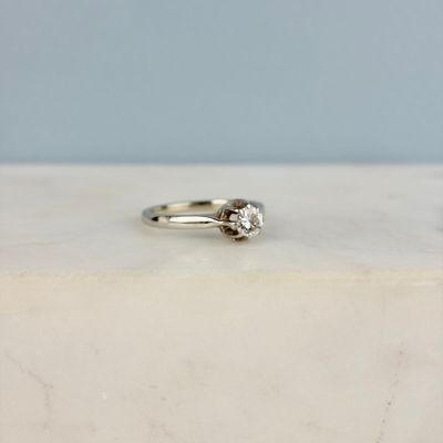 an image of a diamond ring on a marble surface