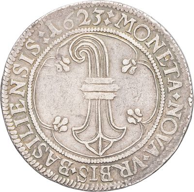 a close up of a silver coin with a cross on it