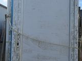 a large white door sitting on top of a pallet
