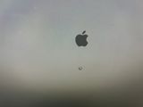 an apple logo on the screen of a laptop computer