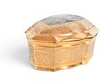 a gold box with a blue stone inside of it