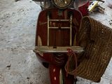 a red scooter with a wicker basket on the back
