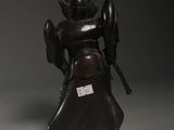 a bronze statue of a woman holding a sword and shield