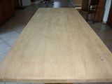 a long wooden table in the middle of a kitchen