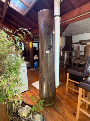 a large wooden pole in the middle of a living room
