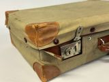 a suitcase with a lock on it sitting on a table