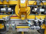 a machine that is working on the back of a truck
