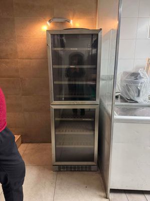 un homme debout devant un réfrigérateur dans une cuisine
