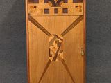 a wooden cabinet with a design on the door