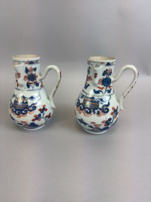 pair of blue and white vases with floral designs on them