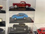 many different models of cars on display in a display case