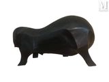 a black sculpture of a cow on a white background