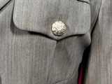 a close up of a suit with a button on the lapel