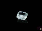 a close up of a diamond on a black surface with a black background