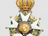 an image of a gold medal with a crown on top of it