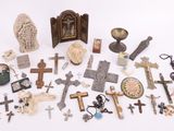 a lot of crosses and other religious items on the table