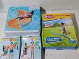 several children ' s books on a white table with oranges and other toys