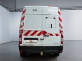 a white van with red and white stripes parked in a room