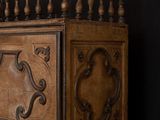 a wooden bed with a black background and a black wall