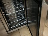 a person that is opening the door of a small oven