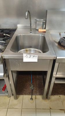 a stainless steel sink in the middle of a kitchen