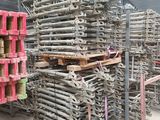 un gros tas de palettes en bois dans un entrepôt