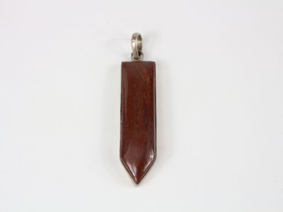 a wooden pendant with a silver clasp on a white background