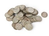 a pile of old coins on a white surface