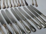 a lot of silverware on a table with a knife and fork