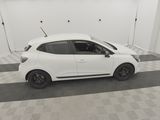 the small white car is parked in a clean room