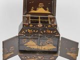 a small wooden box with a drawer inside of it