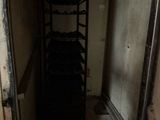a room with a shelf and a door in it