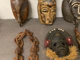 a lot of african masks on the floor