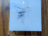 a piece of paper on a wooden table that has a sticker on it