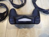 a video game controller sitting on a wooden table