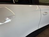 a white car with a sticker on the side of it